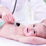Female doctor pediatrician and patient happy smiling child baby