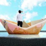 man into a bill boat on a puddle