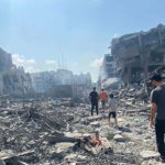 Palestinians inspect the damage following an Israeli airstrike on the El-Remal area in Gaza City